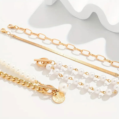 Elegante conjunto de 4 pulseras doradas: serpiente, perlas y eslabones | Oro